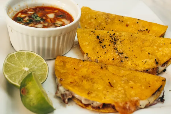 Birria tacos with consomé